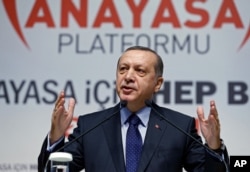 FILE - Turkey’s President Recep Tayyip Erdogan addresses his supporters in Ankara, Jan. 28, 2016. Erdogan told the U.S. Sunday it had to choose between Turkey and the YPG, which it has partnered with to fight the Islamic State group.