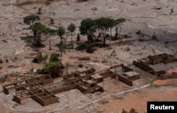 FILE - The debris of the municipal school of Bento Rodrigues district, which was covered with mud after a dam owned by Vale SA and BHP Billiton Ltd. burst, is pictured in Mariana, Brazil, Nov. 10, 2015.