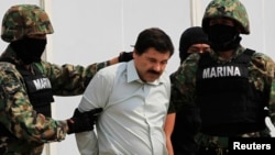 Joaquin Guzman is escorted by soldiers in Mexico City on February 22, 2014.