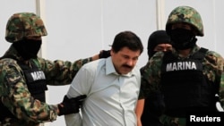FILE - Joaquin Guzman is escorted by soldiers in Mexico City Feb. 22, 2014.