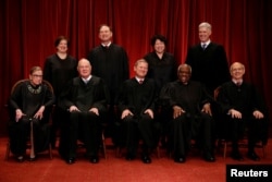 FILE - U.S. Chief Justice John Roberts (seated C), Justice Ruth Bader Ginsburg (front row, L-R), Justice Anthony Kennedy, Justice Clarence Thomas, Justice Stephen Breyer, Justice Elena Kagan (back row, L-R), Justice Samuel Alito, Justice Sonia Sotomayor, and Associate Justice Neil Gorsuch are seen in a group photo at the Supreme Court building in Washington, June 1, 2017. The Supreme Court will start its new term Monday without Justice Kennedy, who retired earlier this year.