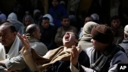 Egyptian Coptic men protest the killing of 21 Coptic Christians by Islamic State militants.