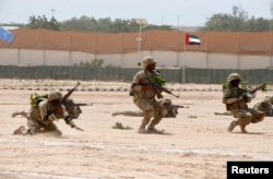FILE - Members of the Somali military perform a defensive drill after attending a commando training exercise in Mogadishu, Jan. 20, 2016.