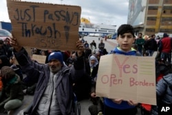 Migrants demand to open the border during a protest at the Athens port of Piraeus, March 17, 2016.