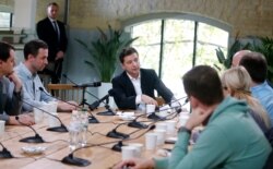 FILE - Ukrainian President Volodymyr Zelenskiy speaks with journalists in Kyiv, Ukraine, Oct. 10, 2019.