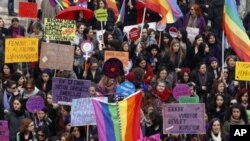 Women shout slogans and hold banners as they march through central Ankara to commemorate International Women's Day, Turkey, March 8, 2012.