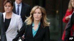FILE - Actress Felicity Huffman departs federal court in Boston, April 3, 2019.
