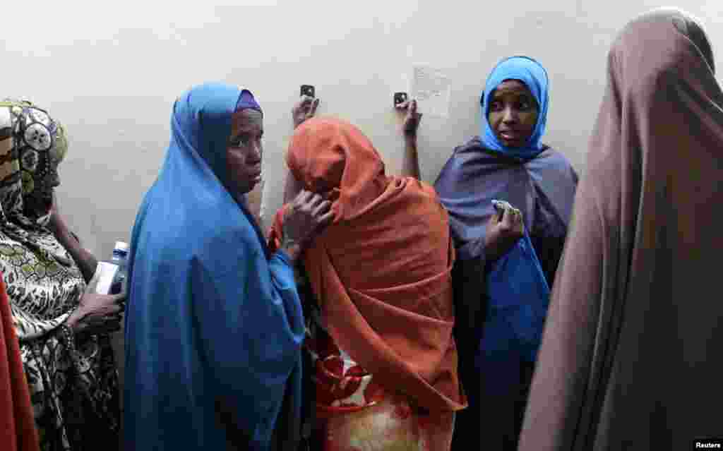 Leyla Ali Adow (C), a suspected Somali illegal migrant arrested in a police swoop, reacts after being processed for deportation at a holding station in Kenya&#39;s capital Nairobi.