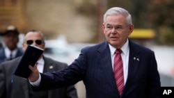 FILE - U.S. Sen. Bob Menendez waves at reporters before entering the federal courthouse in Newark, N.J., for his corruption trial, Nov. 16, 2017. The trial ended in a deadlocked jury; it was announced Jan. 31, 2018, that the government had dropped its case against the senator.