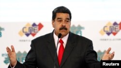 Venezuela's re-elected President Nicolas Maduro gestures after he received a certificate given by the National Electoral Council (CNE), confirming him as winner of Sunday's election, in Caracas, May 22, 2018.