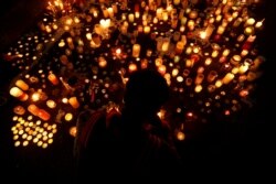FILE - People visit a memorial for victims of a shooting at the Masjid Al Noor mosque in Christchurch, New Zealand, March 18, 2019.