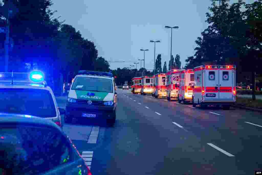 Police cars and ambulances are seen near a shopping mall (the Olympia Einkaufzentrum (OEZ) ) in Munich on July 22, 2016 following shootings.