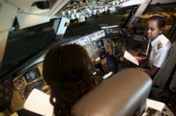FILE - Ethiopian Airlines female pilots prepare the plane before takeoff at Bole international airport in the capital Addis Ababa, Nov. 19, 2015.