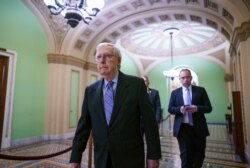 Senate Minority Leader Mitch McConnell, R-Ky., arrives to speak to reporters ahead of a test vote on a bipartisan infrastructure deal senators brokered with President Joe Biden, in Washington, July 21, 2021.
