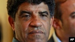 Former Libyan intelligence chief Abdullah al-Senussi, shown here Aug. 21, 2011, speaking with reporters in Tripoli, Libya.