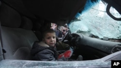A boy cries after government airstrikes in the town of Ariha, in Idlib province, Syria, Jan. 15, 2020. 