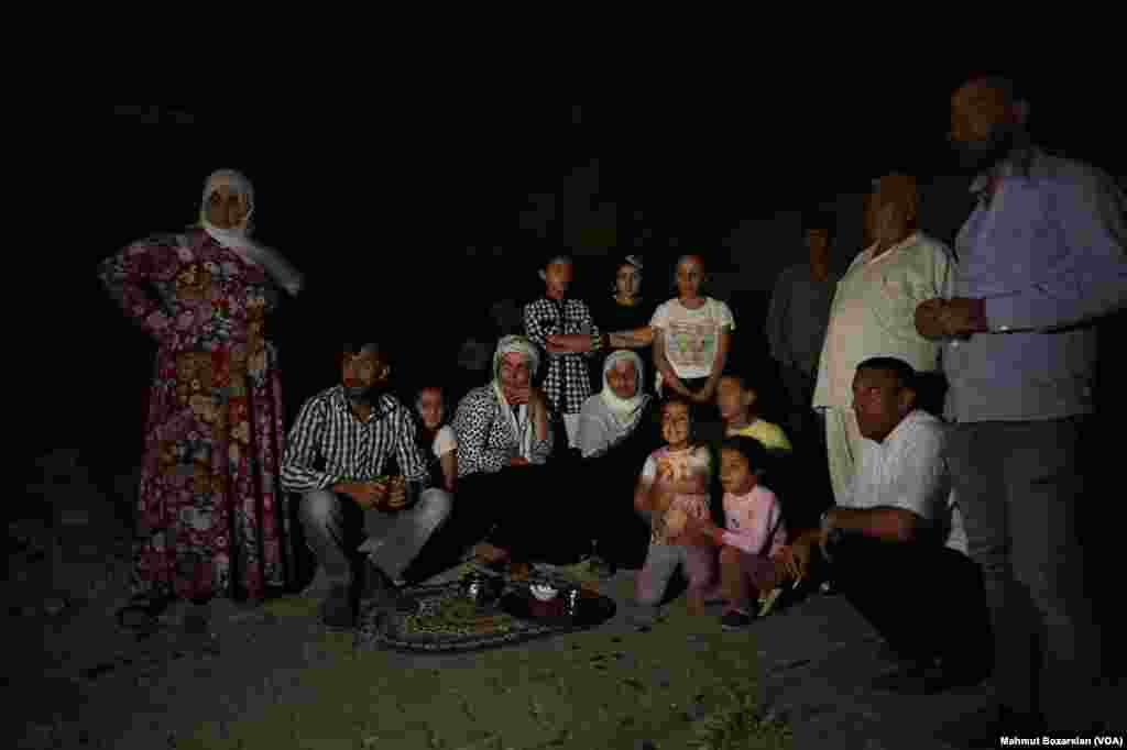 The government has cut power and water to Sur, in Diyarbakir, Turkey, as efforts are made to rebuild it. Residents who remain gather outside at night, under the light of street lamps.