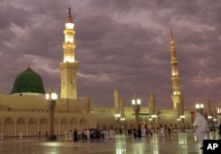 FILE -- In this July 5, 2013 file photo, worshipers visit the Prophet's Mosque in Medina, Saudi Arabia.