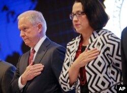 U.S. Attorney General Jeff Sessions and U.S. Ambassador to El Salvador Jean Elizabeth Manes stand during the playing of the U.S. national anthem during a graduation ceremony at the International Law Enforcement Academy in San Salvador, El Salvador, July 2