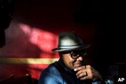 Xavier Bryant, 33, an independent pharmacy owner, sits at a restaurant while meeting a friend in East Atlanta, Georgia, in DeKalb County, Jan. 5, 2017.