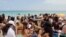 Spring breakers gather in South Beach, Monday, March 14, 2016, at Miami Beach, Fla. College students relax and have fun during their Spring Break. (AP Photo/Alan Diaz)