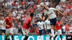 Tottenham's Harry Kane heads the ball during the English FA Cup semifinal soccer match between Manchester United and Tottenham Hotspur at Wembley stadium in London, Saturday, April 21, 2018. (AP Photo/Kirsty Wigglesworth)