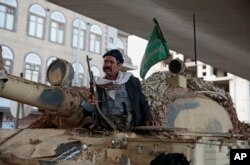 A Houthi Shi'ite fighter guards a street leading to the residence of former President Ali Abdullah Saleh, in Sana'a, Yemen, Dec. 4, 2017.