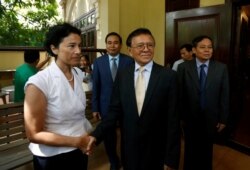 FILE - Leader of the Cambodia National Rescue Party (CNRP) Kem Sokha shakes hands with French Ambassador to Cambodia Eva Nguyen Binhin at his home in Phnom Penh, Nov. 11, 2019.