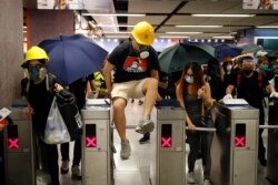 Protesters exit the Causeway Bay MTR station as they proceed to the anti-extradition bill protest destination, in Hong Kong, Aug. 4, 2019.