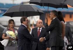 President Barack Obama, right, shakes hands with Cuba's Foreign Minister Bruno Rodriguez