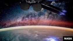 An astronaut took this broad, short-lens photograph of Earth’s night lights and Milky Way while looking out over the remote reaches of the central equatorial Pacific Ocean.