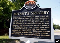 A Mississippi Freedom Trail marker recaps the significance of Bryant's Grocery and Meat Market, left, now in ruins, in Money, Miss., where in 1955, 14-year old Emmett Till allegedly whistled, grabbed and made sexual advances to a white woman.