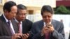 FILE PHOTO - Senior Cambodian government officers are using their smartphones while awaiting the return of Cambodian Prime Minister Hun Sen from France at Phnom Penh International Airport.