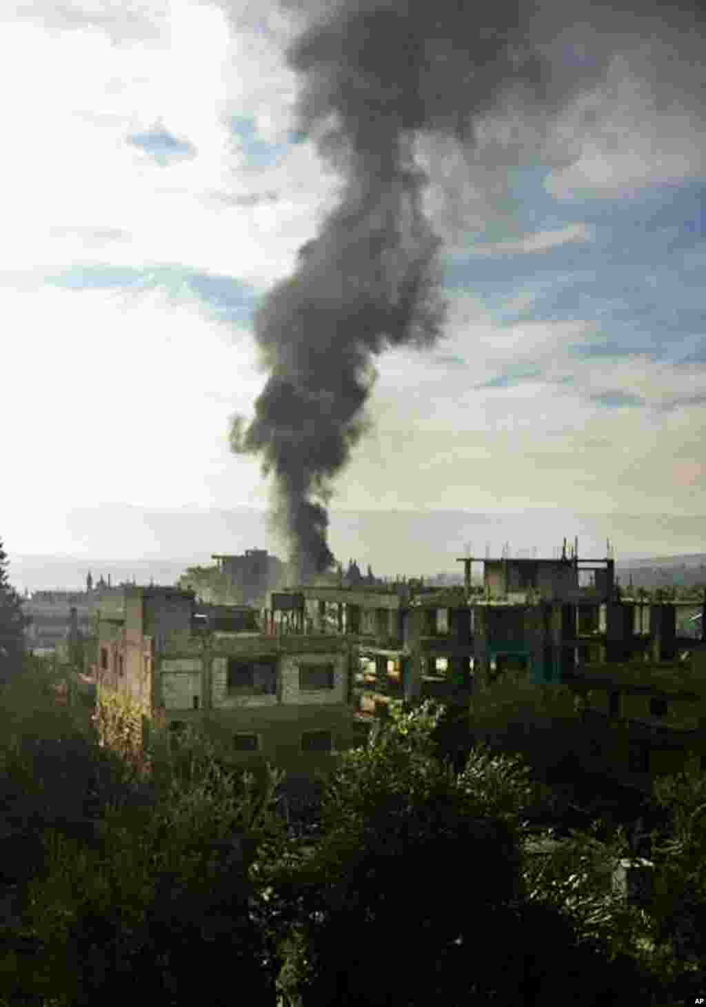 Black smoke rises from the site of a car bomb explosion in Hermel, northeast Lebanon, Jan. 16, 2014.