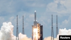 FILE - The Long March 5 Y-4 rocket, carrying an unmanned Mars probe of the Tianwen-1 mission, takes off from Wenchang Space Launch Center in Wenchang, Hainan Province, China, July 23, 2020. 