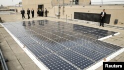 FILE - Solar panels are seen on the roof of the Department of Energy in Washington, March 19, 2015. 