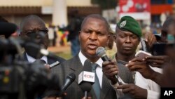 FILE - Faustin-Archange Touadera (C) is seen speaking to the media in downtown Bangui, Central African Republic, Jan. 5, 2013.