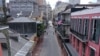 FILE - The normally bustling tourist mecca of Bourbon Street lies deserted in the early afternoon during shelter in place orders to slow the spread of the coronavirus, in New Orleans, Louisiana, March 27, 2020.