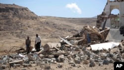 FILE - Forensic experts inspect the rubble of a house destroyed by a Saudi-led airstrikes on the outskirts of Sanaa, Yemen, Feb. 16, 2017.