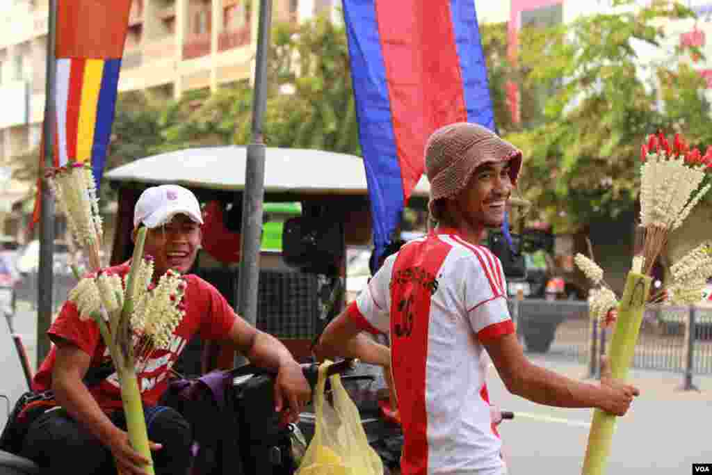 អ្នកលក់ផ្កាសម្រាប់បូជាព្រះ នៅមុខវត្តកោះ នៅថ្ងៃបិណ្ឌមួយ កាលពីថ្ងៃទី២៨ ខែកញ្ញា ឆ្នាំ២០១៥។ (ឡេង ឡែន/VOA)