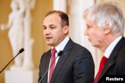 FILE - Kosovo's Foreign Minister Enver Hoxhaj, left, and his Finnish counterpart Erkki Tuomioja attend a news conference in Helsinki March 31, 2014.