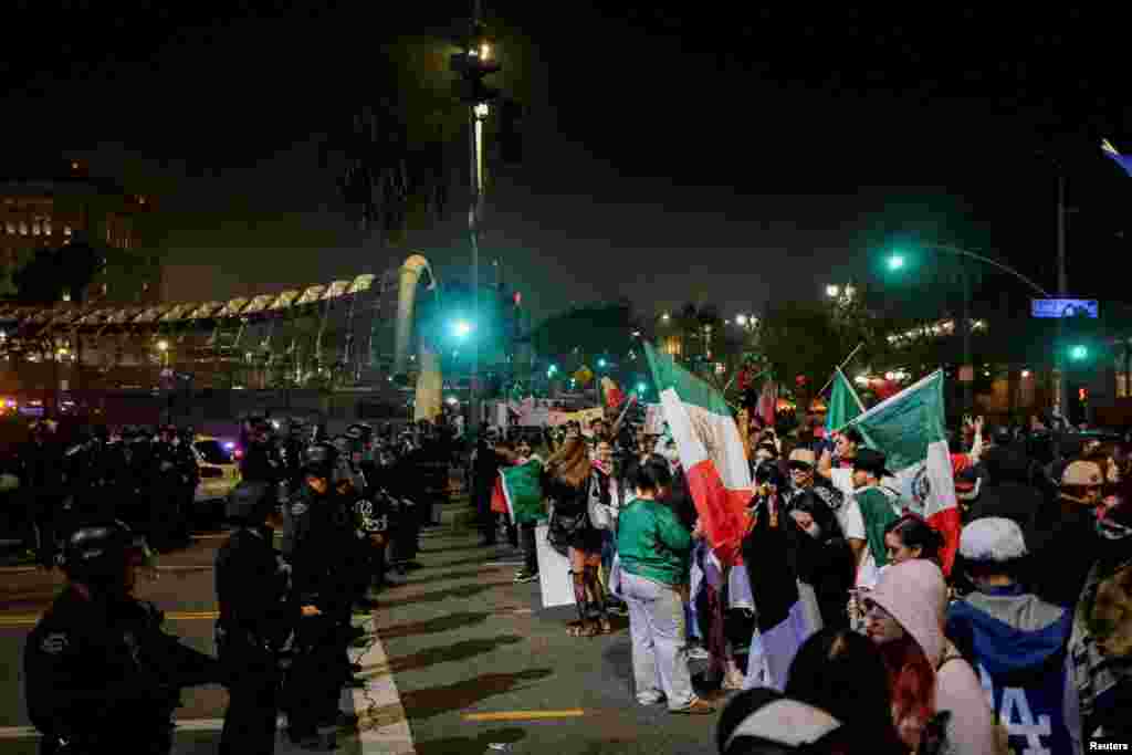 LAPD officers block off street access during a protest against arrests and deportations of migrants in Los Angeles, California, Feb. 2, 2025.