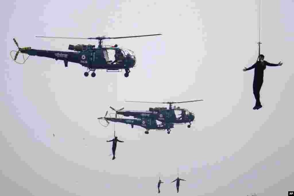 Indian navy personnel display their skills during Naval Day celebrations in Mumbai.