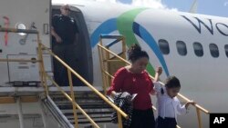 Donelda Pulex and her 5-year-old daughter Marelyn, step off a chartered flight from the U.S. in Guatemala City, Guatemala, after the two were deported after being separated crossing the U.S. border. Pulex said she was tormented by the idea she’d never see her child again. (AP Photo/Colleen Long)