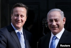 Britain's Prime Minister David Cameron (L) greets Israel's Prime Minister Benjamin Netanyahu as he arrives at Number 10 Downing Street in London, Britain, Sept. 10, 2015.