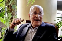 In this Sept. 19, 2015 photo, Mohamed Heikal jokes with friends days before his 92nd birthday at his house, in Cairo, Egypt.