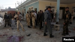 Afghan security forces inspect the site of a suicide attack in Jalalabad, Afghanistan, Jan. 17, 2016. 