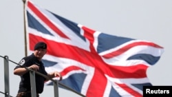 A crew member of the HMS Albion, the British Royal Navy flagship amphibious assault ship, is seen upon the ship's arrival at Harumi Pier in Tokyo, Japan, Aug. 3, 2018. 