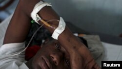 Givenchi Predelus, who suffers from cholera, rests on a cot at the Cholera Treatment Center run by the Haitian Ministry of Public Health and Population (MSPP) in collaboration with Doctors Without Borders (MSF) in Port-au-Prince, April 13, 2015.