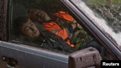 Rossiyada, avtomobilda tunayotgan ishchi muhojirlar. Krasnaya Polyana qishlog'i, 21-sentabr, 2013-yil.